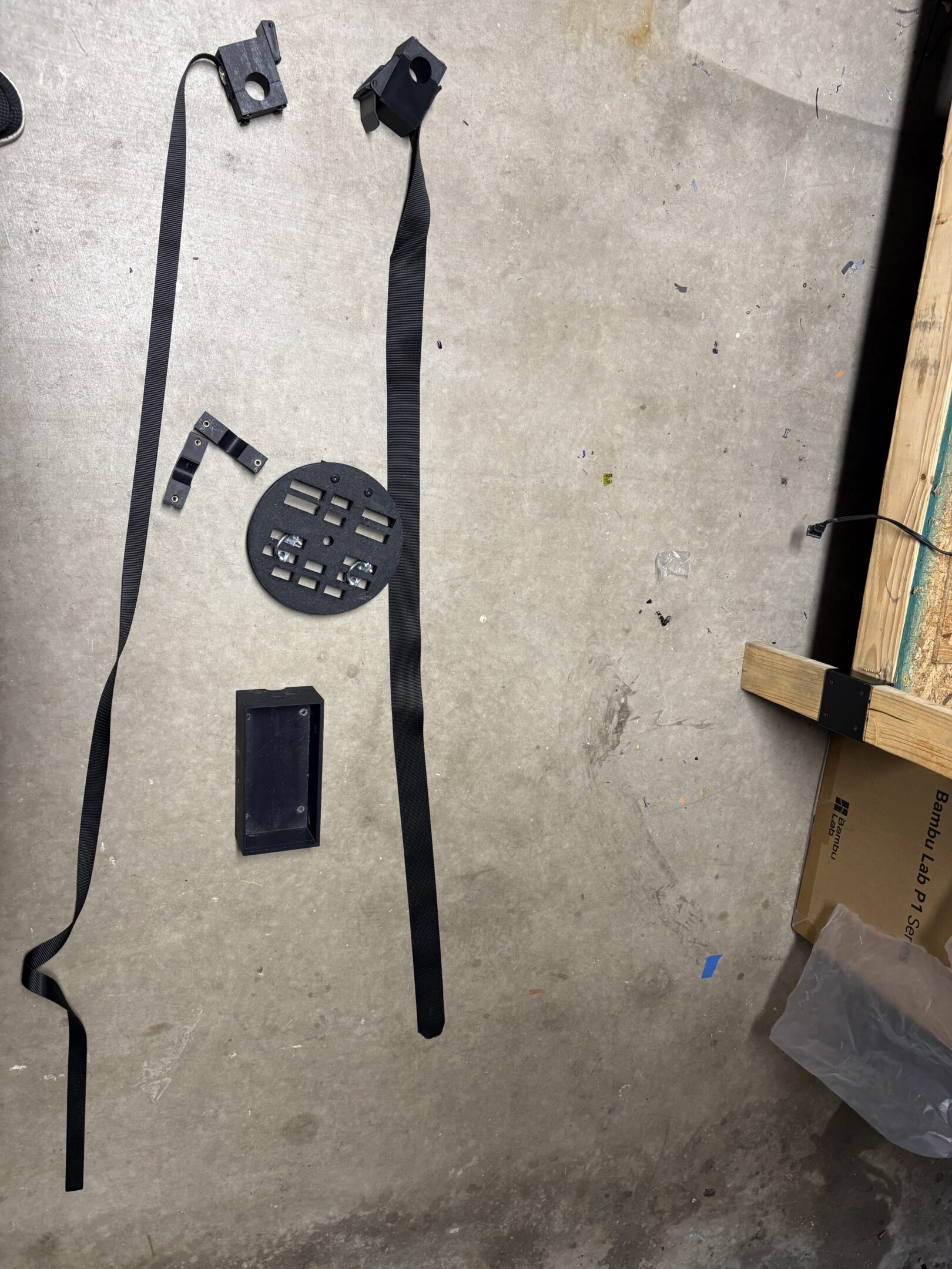 black mounting hardware and straps on concrete